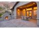 Cozy covered patio featuring an outdoor fireplace and dining area at 9715 E Allison Way, Scottsdale, AZ 85262