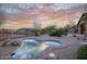 Outdoor living space with a spa, rock feature, desert landscaping, and view of the mountains at 9715 E Allison Way, Scottsdale, AZ 85262