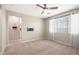 Spacious bedroom with carpet floors and lots of natural light at 9829 E Talon Ave, Mesa, AZ 85212
