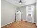 Cozy bedroom features wood-look floors, a ceiling fan, and a large mirror for a modern touch at 9829 E Talon Ave, Mesa, AZ 85212
