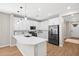 Modern kitchen with white cabinets, quartz countertops, and stainless steel appliances at 9829 E Talon Ave, Mesa, AZ 85212