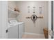 Efficient laundry room with washer, dryer, and storage shelves for organized living at 9829 E Talon Ave, Mesa, AZ 85212