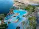 Overhead view of a community pool, a water park and lawn by a scenic lake at 10130 S 185Th Dr, Goodyear, AZ 85338