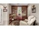 Relaxing bar area with built-in shelving and a plush recliner, perfect for unwinding at 10130 S 185Th Dr, Goodyear, AZ 85338