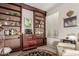 Relaxing bar area with built-in shelving and a nearby window, perfect for unwinding at 10130 S 185Th Dr, Goodyear, AZ 85338
