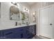 Modern bathroom featuring a dual sink vanity with stylish fixtures, a decorative mirror, and plenty of storage space at 10130 S 185Th Dr, Goodyear, AZ 85338
