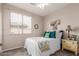 Cozy bedroom with neutral tones, plush furnishings, and ample natural light, creating a warm and inviting atmosphere at 10130 S 185Th Dr, Goodyear, AZ 85338