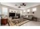 Spacious living room with a cozy fireplace, neutral tones, and lots of natural light, perfect for relaxing and entertaining guests at 10130 S 185Th Dr, Goodyear, AZ 85338