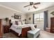Comfortable main bedroom offers a tranquil retreat with plush furnishings, a ceiling fan, and soft natural light at 10130 S 185Th Dr, Goodyear, AZ 85338