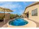 Backyard pool and patio with desert landscape and multiple umbrellas at 10130 S 185Th Dr, Goodyear, AZ 85338