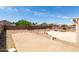 The backyard is spacious with a concrete patio, basketball hoop, and block wall at 10909 W Frier Dr, Glendale, AZ 85307