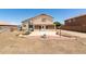 A spacious backyard features a covered patio, concrete patios, and a block wall at 10909 W Frier Dr, Glendale, AZ 85307