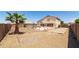 Backyard with covered patio, palm trees, concrete patio, and a block wall at 10909 W Frier Dr, Glendale, AZ 85307