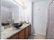 Bathroom features a granite countertop, elegant black vessel sink, and a decorative mirror at 10909 W Frier Dr, Glendale, AZ 85307