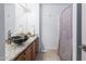 Bathroom features a granite countertop, elegant black vessel sink, and a decorative mirror at 10909 W Frier Dr, Glendale, AZ 85307