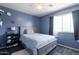 Comfortable bedroom featuring a neutral color scheme, a large window, and a ceiling fan at 10909 W Frier Dr, Glendale, AZ 85307