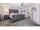 Cozy bedroom featuring a large bed, soft lighting, and an attached bathroom for added convenience at 10909 W Frier Dr, Glendale, AZ 85307