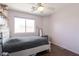 Cozy bedroom featuring a soft bed, a bright window, and laminate wood flooring at 10909 W Frier Dr, Glendale, AZ 85307