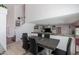 Open-concept dining room features a modern table with six chairs and neutral color palette at 10909 W Frier Dr, Glendale, AZ 85307