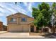 Charming two-story home featuring a spacious three-car garage and mature shade tree at 10909 W Frier Dr, Glendale, AZ 85307