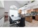 Eat-in kitchen featuring an island and stainless steel appliances adjacent to the dining area at 10909 W Frier Dr, Glendale, AZ 85307