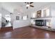 Spacious living room featuring a fireplace, high ceilings, and wood-look flooring at 10909 W Frier Dr, Glendale, AZ 85307
