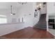 Living room with wood-look flooring, neutral paint, ceiling fan, and stairway at 10909 W Frier Dr, Glendale, AZ 85307