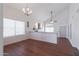 Living room with wood-look flooring, neutral paint, ceiling fan, and fireplace at 10909 W Frier Dr, Glendale, AZ 85307