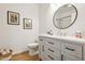 Bright bathroom featuring a modern vanity, round mirror, and updated fixtures at 14575 W Mountain View Blvd # 11308, Surprise, AZ 85374