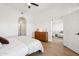 Bright bedroom with wood floors, dresser, and open door to the living room at 14575 W Mountain View Blvd # 11308, Surprise, AZ 85374