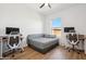 Bedroom featuring a bed and two desks, perfect for a home office at 14575 W Mountain View Blvd # 11308, Surprise, AZ 85374