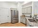 Modern kitchen with stainless steel fridge, granite counters, and ample cabinet space at 14575 W Mountain View Blvd # 11308, Surprise, AZ 85374
