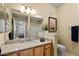 Well-lit bathroom featuring a granite countertop, wooden cabinets, and a shower with sliding glass doors at 14950 W Mountain View Blvd # 7111, Surprise, AZ 85374