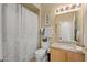Cozy bathroom with a shower and bath combination, granite countertops, and classic framed decorations at 14950 W Mountain View Blvd # 7111, Surprise, AZ 85374