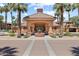 Exterior of a community building with a fountain, covered walkway, and a manicured garden at 14950 W Mountain View Blvd # 7111, Surprise, AZ 85374