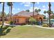 Community clubhouse with pool, palm trees, and manicured landscaping at 14950 W Mountain View Blvd # 7111, Surprise, AZ 85374