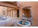 Exterior courtyard featuring a water fountain, textured walls, and tiled walkway at 14950 W Mountain View Blvd # 7111, Surprise, AZ 85374