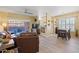 Open-concept living room with modern flooring that flows to the kitchen and dining area at 14950 W Mountain View Blvd # 7111, Surprise, AZ 85374