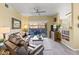 Comfortable living room features a ceiling fan and access to an outdoor patio at 14950 W Mountain View Blvd # 7111, Surprise, AZ 85374