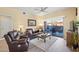 Inviting living room with comfortable leather seating and access to outdoor patio at 14950 W Mountain View Blvd # 7111, Surprise, AZ 85374