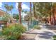 View of a community pool area surrounded by palm trees and vibrant greenery at 14950 W Mountain View Blvd # 7111, Surprise, AZ 85374