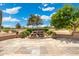 Landscaped backyard featuring stone waterfall, tiled patio, desert plants, and serene outdoor space at 15133 W Wildfire Dr, Surprise, AZ 85374