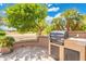 Backyard outdoor kitchen featuring built-in grill and prep area, perfect for entertaining in the landscaped yard at 15133 W Wildfire Dr, Surprise, AZ 85374