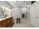 Bathroom featuring single sinks, a granite countertop, tan tile, and a walk-in shower at 15133 W Wildfire Dr, Surprise, AZ 85374