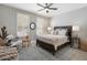 Bright bedroom with a ceiling fan, plantation shutters, and side tables with lamps at 15133 W Wildfire Dr, Surprise, AZ 85374