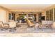 Spacious covered patio with comfortable seating and tiled flooring perfect for outdoor entertaining and relaxation at 15133 W Wildfire Dr, Surprise, AZ 85374