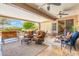 Inviting covered patio featuring comfortable seating, decorative rugs, and a relaxing outdoor ambiance at 15133 W Wildfire Dr, Surprise, AZ 85374