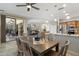 Dining area with wood table, chairs and slider to covered patio in an open concept home at 15133 W Wildfire Dr, Surprise, AZ 85374