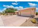Spacious home featuring a large driveway and well-maintained desert landscaping at 15133 W Wildfire Dr, Surprise, AZ 85374
