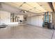 Spacious three car garage with epoxy floor and built in storage cabinets at 15133 W Wildfire Dr, Surprise, AZ 85374